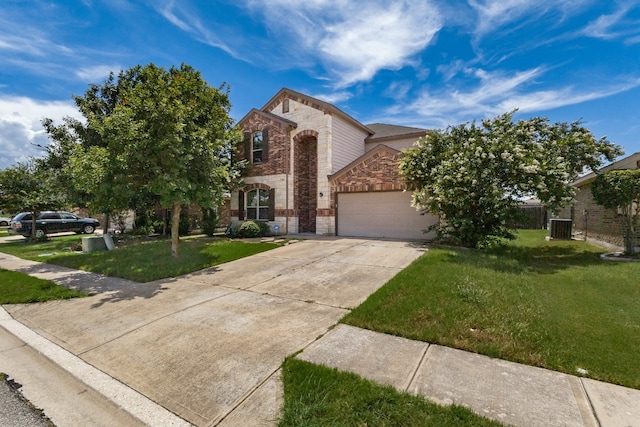 107 Marklawn Ln, Hutto, TX 78634 - view of front of home featuring brick siding, stone siding, an attached garage, and a front lawn