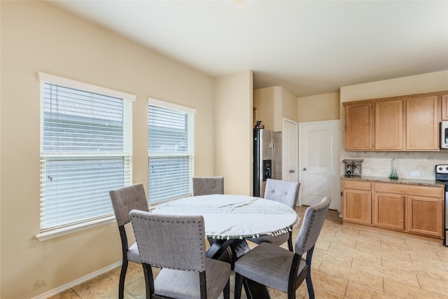 107 Marklawn Ln, Hutto, TX 78634 - dining room featuring light tile patterned flooring and baseboards