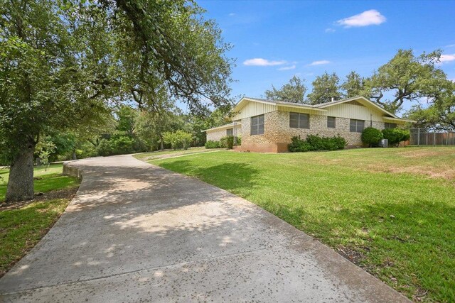 9504 Flintrock Cir, Austin, TX 78737 - view of side of home featuring driveway and brick siding