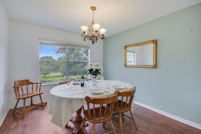 9504 Flintrock Cir, Austin, TX 78737 - dining room with a chandelier, wood finished floors, and baseboards