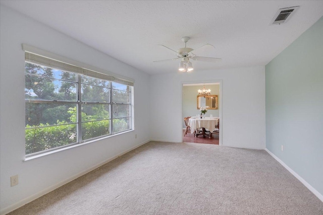 9504 Flintrock Cir, Austin, TX 78737 - empty room with a chandelier, carpet floors, a ceiling fan, and baseboards