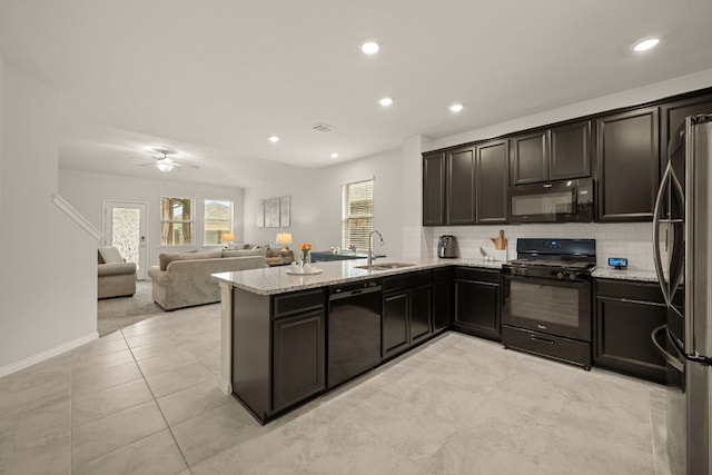 13712 Fallsprings Way, Manor, TX 78653 - kitchen featuring black appliances, light stone counters, a sink, a peninsula, and recessed lighting
