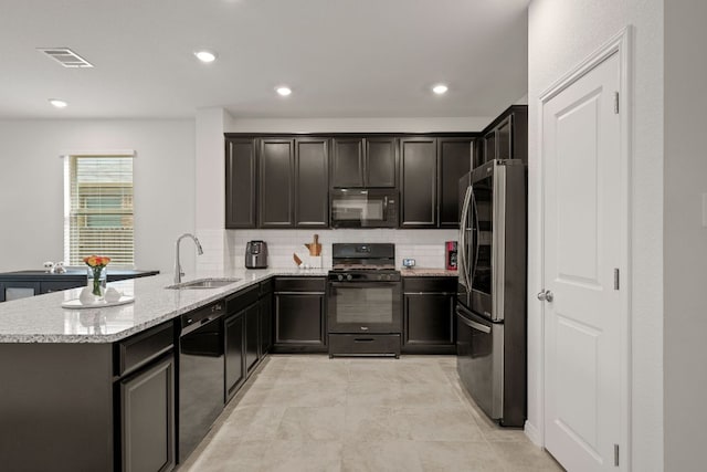 13712 Fallsprings Way, Manor, TX 78653 - kitchen featuring black appliances, a sink, light stone countertops, backsplash, and a peninsula