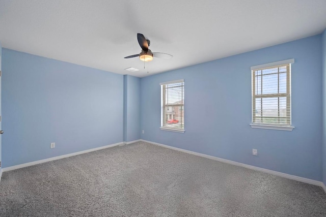 13712 Fallsprings Way, Manor, TX 78653 - unfurnished room featuring healthy amount of natural light, ceiling fan, carpet flooring, and baseboards