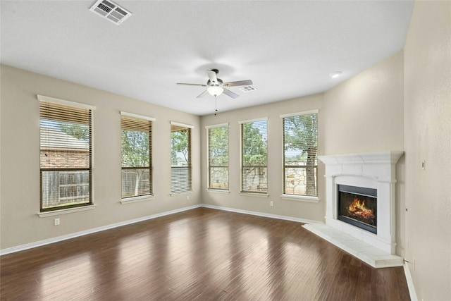 2804 Prosperity, Leander, TX 78641 - unfurnished living room featuring a ceiling fan, dark wood-style floors, and a glass covered fireplace
