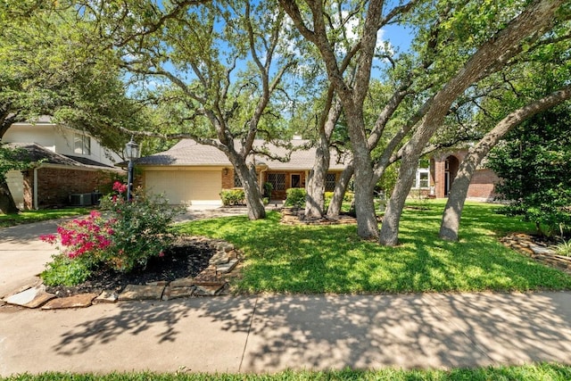 8417 Cornerwood Dr, Austin, TX 78717 - view of front facade with a garage, brick siding, a front yard, and concrete driveway