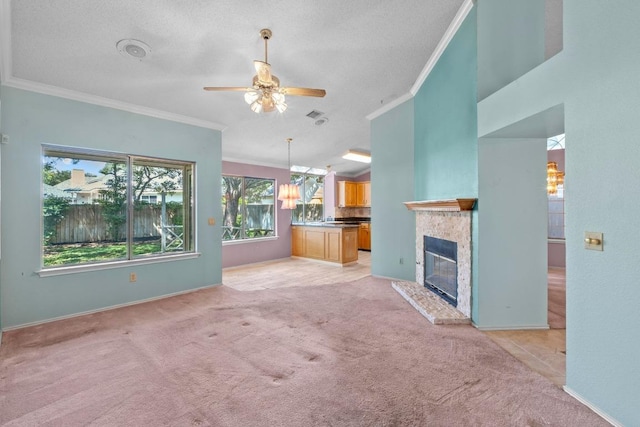 8417 Cornerwood Dr, Austin, TX 78717 - unfurnished living room with crown molding, light colored carpet, a ceiling fan, a tiled fireplace, and a textured ceiling