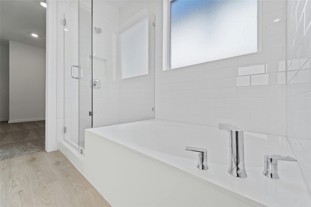 632 Deerpath St, Leander, TX 78641 - bathroom featuring a shower stall, a garden tub, and wood finished floors