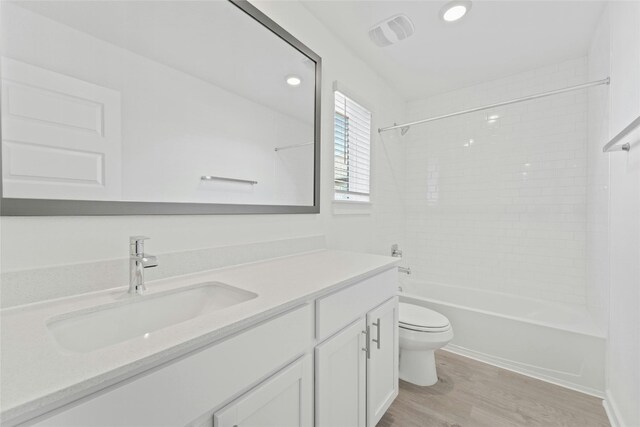632 Deerpath St, Leander, TX 78641 - bathroom featuring toilet, vanity, wood finished floors, bathtub / shower combination, and recessed lighting