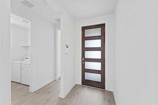 632 Deerpath St, Leander, TX 78641 - entrance foyer with light wood-style flooring, washing machine and clothes dryer, and baseboards