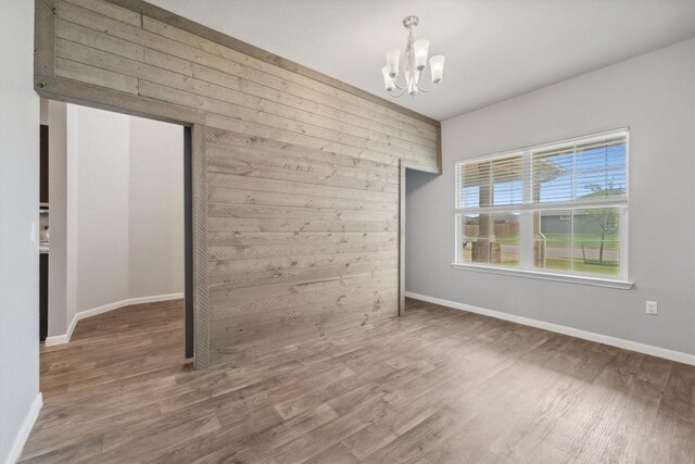 1008 Comal Run, Hutto, TX 78634 - empty room with a chandelier, wood finished floors, and baseboards
