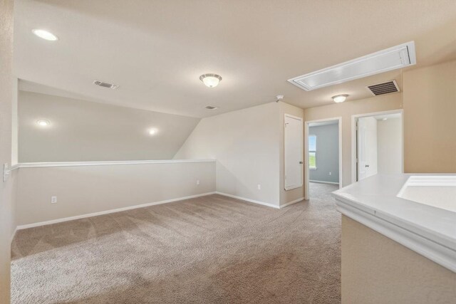 1008 Comal Run, Hutto, TX 78634 - bonus room featuring attic access, light carpet, baseboards, and lofted ceiling
