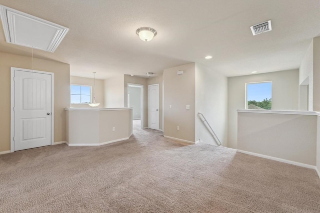 1008 Comal Run, Hutto, TX 78634 - spare room with attic access, carpet floors, and baseboards