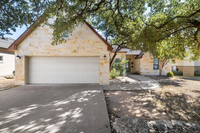 15100 General Williamson Dr, Austin, TX 78734 - view of front of home featuring stone siding and concrete driveway