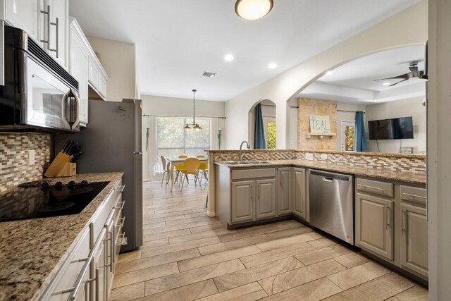 15100 General Williamson Dr, Austin, TX 78734 - kitchen featuring stainless steel dishwasher, black electric stovetop, a sink, backsplash, and a ceiling fan