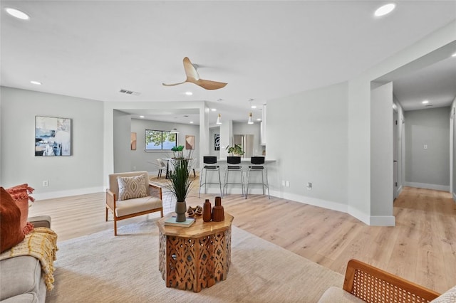 7065 Wheatfield Way, Kyle, TX 78640 - living room with light wood-style floors, ceiling fan, and recessed lighting