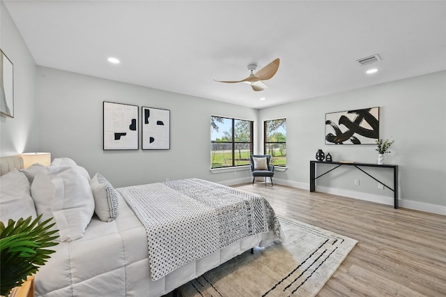 7065 Wheatfield Way, Kyle, TX 78640 - bedroom with wood finished floors, recessed lighting, and a ceiling fan
