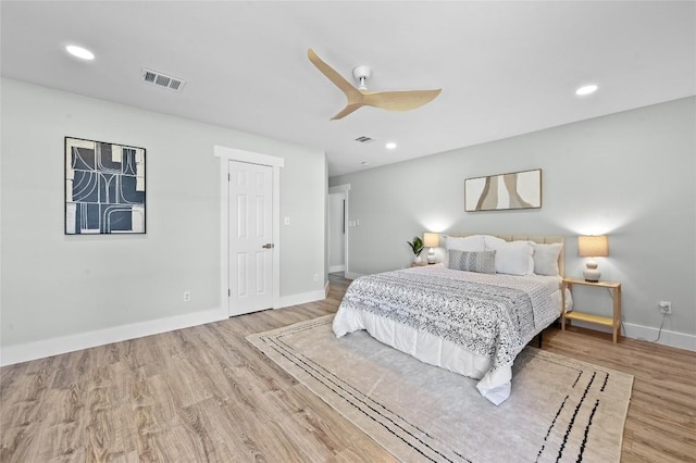 7065 Wheatfield Way, Kyle, TX 78640 - bedroom featuring wood finished floors, ceiling fan, and recessed lighting