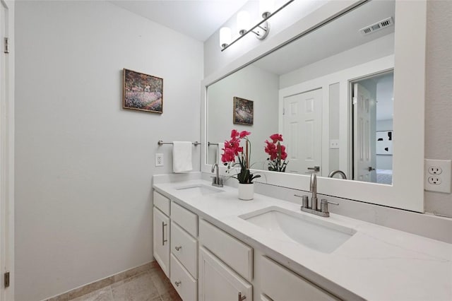 7065 Wheatfield Way, Kyle, TX 78640 - full bath with double vanity and baseboards