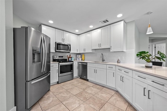 7065 Wheatfield Way, Kyle, TX 78640 - kitchen with appliances with stainless steel finishes, tasteful backsplash, light countertops, and recessed lighting