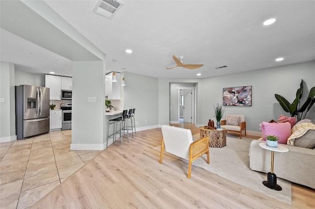 7065 Wheatfield Way, Kyle, TX 78640 - living room featuring recessed lighting, light wood-type flooring, and a ceiling fan