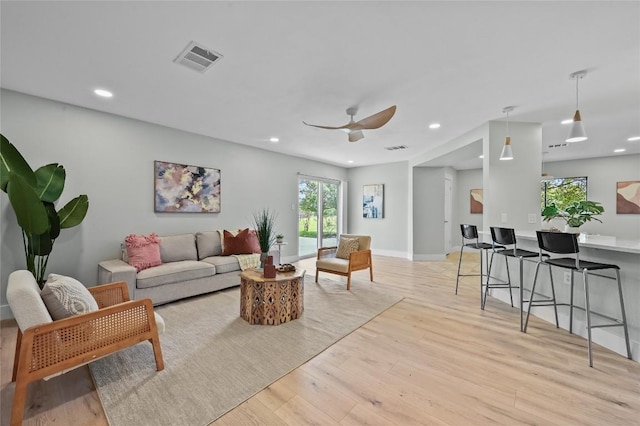 7065 Wheatfield Way, Kyle, TX 78640 - living room featuring healthy amount of natural light, light wood-type flooring, recessed lighting, and ceiling fan