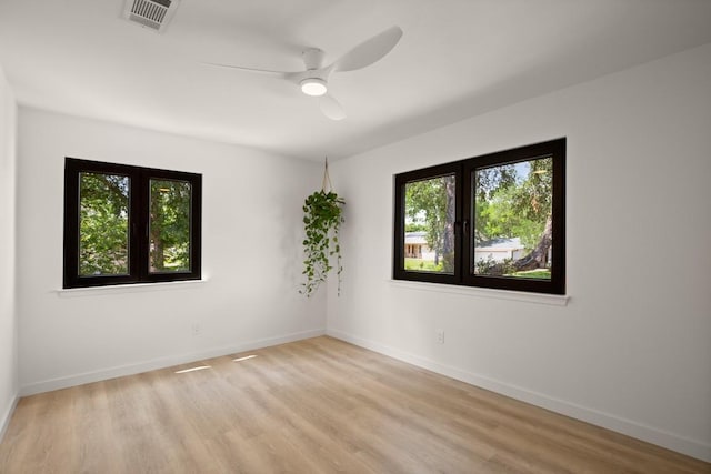 3809 Eton Ln, Austin, TX 78727 - spare room featuring plenty of natural light, light wood-style flooring, baseboards, and a ceiling fan
