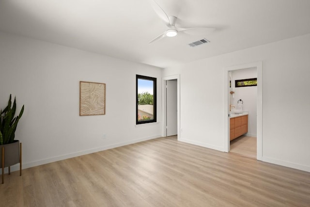 3809 Eton Ln, Austin, TX 78727 - unfurnished bedroom with light wood-style floors, baseboards, ensuite bathroom, and ceiling fan
