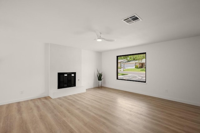 3809 Eton Ln, Austin, TX 78727 - unfurnished living room with a glass covered fireplace, ceiling fan, and wood finished floors