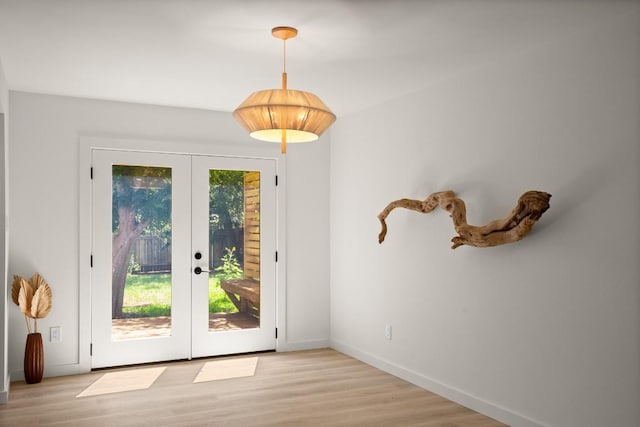 3809 Eton Ln, Austin, TX 78727 - doorway to outside with french doors, light wood-style flooring, and baseboards