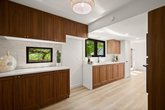 3809 Eton Ln, Austin, TX 78727 - kitchen featuring tasteful backsplash, light countertops, light wood-style flooring, a sink, and recessed lighting