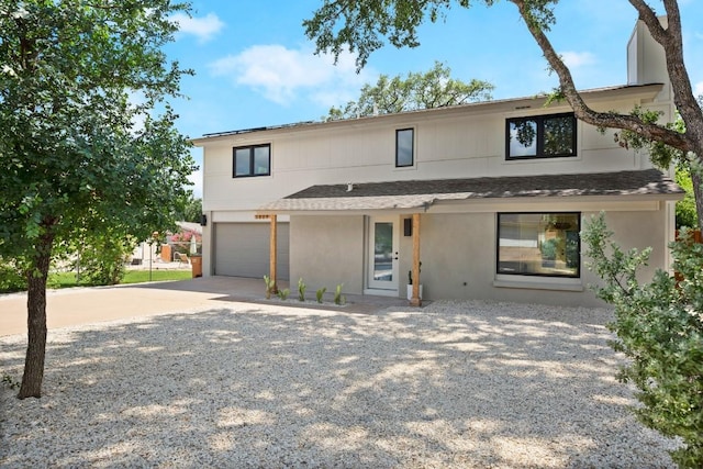 3809 Eton Ln, Austin, TX 78727 - view of front of property with a shingled roof, driveway, an attached garage, and stucco siding