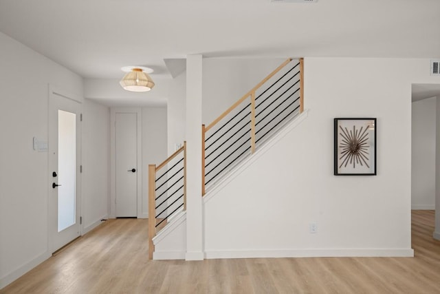 3809 Eton Ln, Austin, TX 78727 - foyer entrance with light wood finished floors, stairway, and baseboards