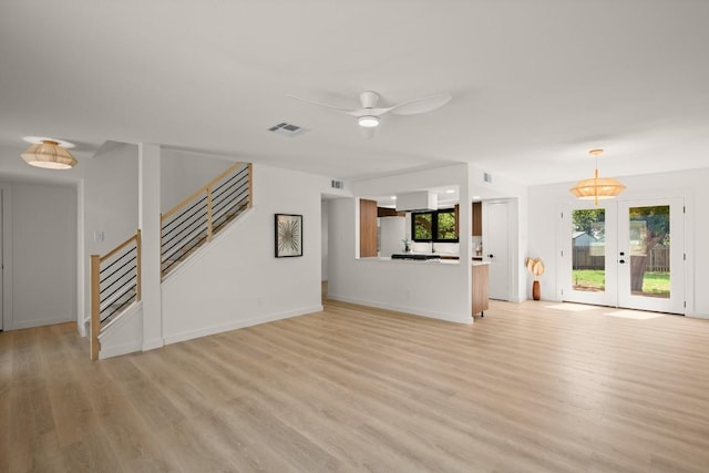 3809 Eton Ln, Austin, TX 78727 - unfurnished living room with light wood-style flooring, a ceiling fan, stairway, and french doors