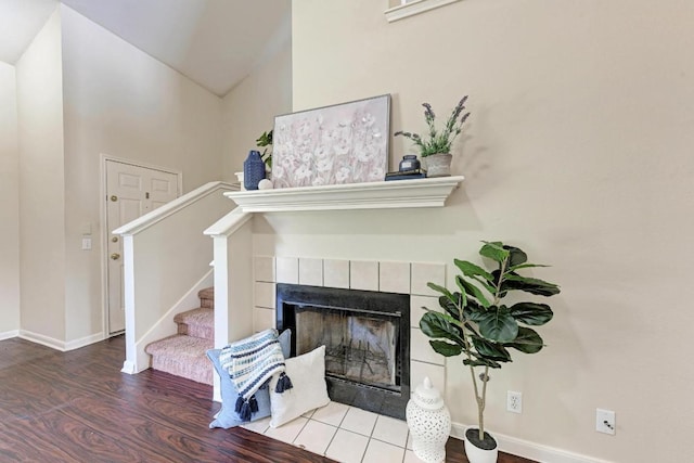 1101 Winecup Ct, Leander, TX 78641 - living area featuring wood finished floors, a fireplace, baseboards, stairway, and lofted ceiling