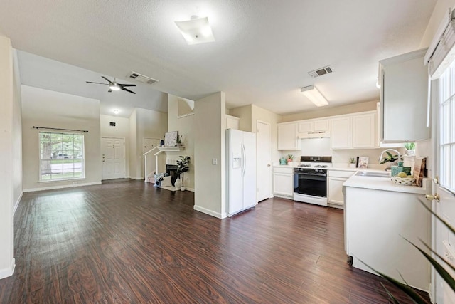 1101 Winecup Ct, Leander, TX 78641 - kitchen featuring white appliances, open floor plan, light countertops, dark wood finished floors, and ceiling fan