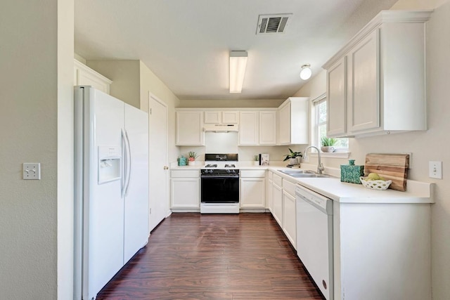 1101 Winecup Ct, Leander, TX 78641 - kitchen featuring white appliances, a sink, under cabinet range hood, dark wood-style flooring, and white cabinets