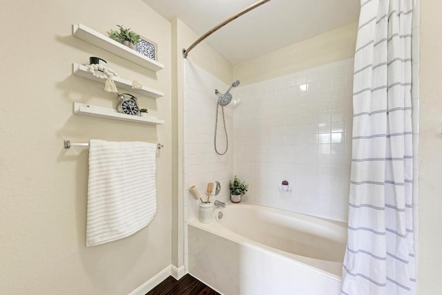 1101 Winecup Ct, Leander, TX 78641 - full bath featuring shower / bath combo, baseboards, and wood finished floors