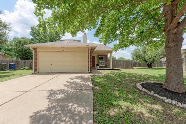 1101 Winecup Ct, Leander, TX 78641 - ranch-style home with a garage, concrete driveway, a chimney, and brick siding