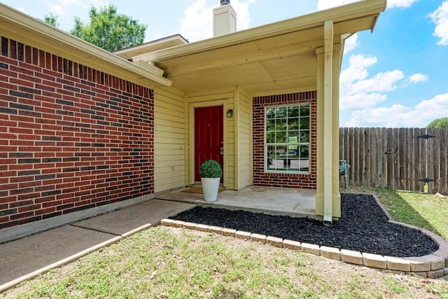 1101 Winecup Ct, Leander, TX 78641 - view of exterior entry featuring brick siding and a chimney