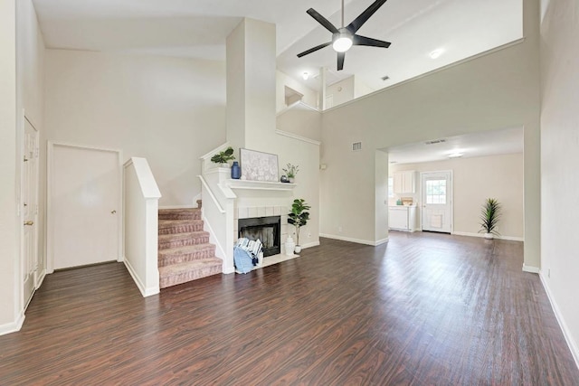1101 Winecup Ct, Leander, TX 78641 - unfurnished living room featuring a high ceiling, dark wood-style flooring, ceiling fan, baseboards, and stairway
