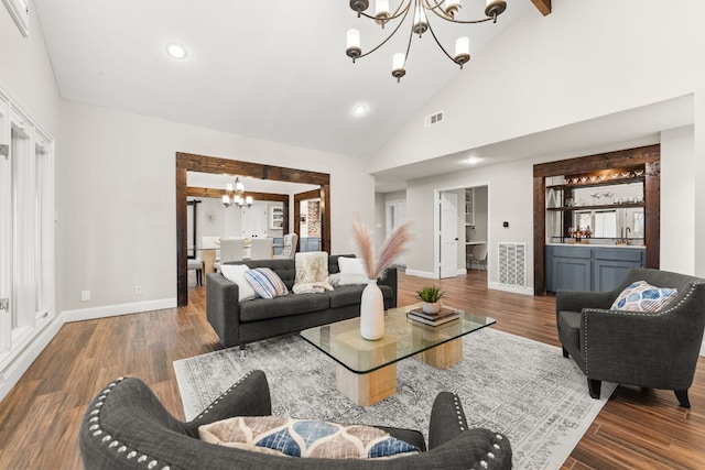 101 Explorer Cv, Lakeway, TX 78734 - living room with a chandelier, high vaulted ceiling, baseboards, wood finished floors, and recessed lighting