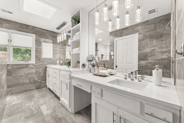 101 Explorer Cv, Lakeway, TX 78734 - full bath with tile walls, double vanity, and marble finish floors
