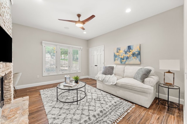 101 Explorer Cv, Lakeway, TX 78734 - living area with ceiling fan, a fireplace, baseboards, wood finished floors, and recessed lighting