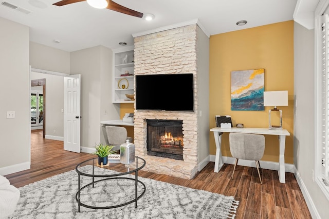 101 Explorer Cv, Lakeway, TX 78734 - living room featuring a ceiling fan, wood finished floors, a fireplace, and baseboards