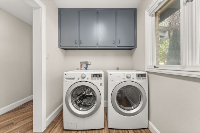 101 Explorer Cv, Lakeway, TX 78734 - laundry area featuring cabinet space, separate washer and dryer, baseboards, and wood finished floors