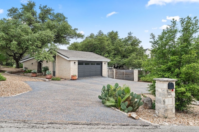 101 Explorer Cv, Lakeway, TX 78734 - view of front of house featuring driveway, brick siding, and a tiled roof