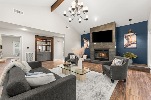 101 Explorer Cv, Lakeway, TX 78734 - living room with wood finished floors, beam ceiling, a large fireplace, high vaulted ceiling, and baseboards