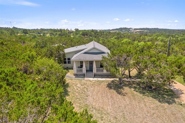 415 Angel Fire Rd, Dripping Springs, TX 78620 - back of house featuring a porch and a forest view