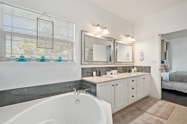 415 Angel Fire Rd, Dripping Springs, TX 78620 - ensuite bathroom with double vanity, crown molding, and a bathtub